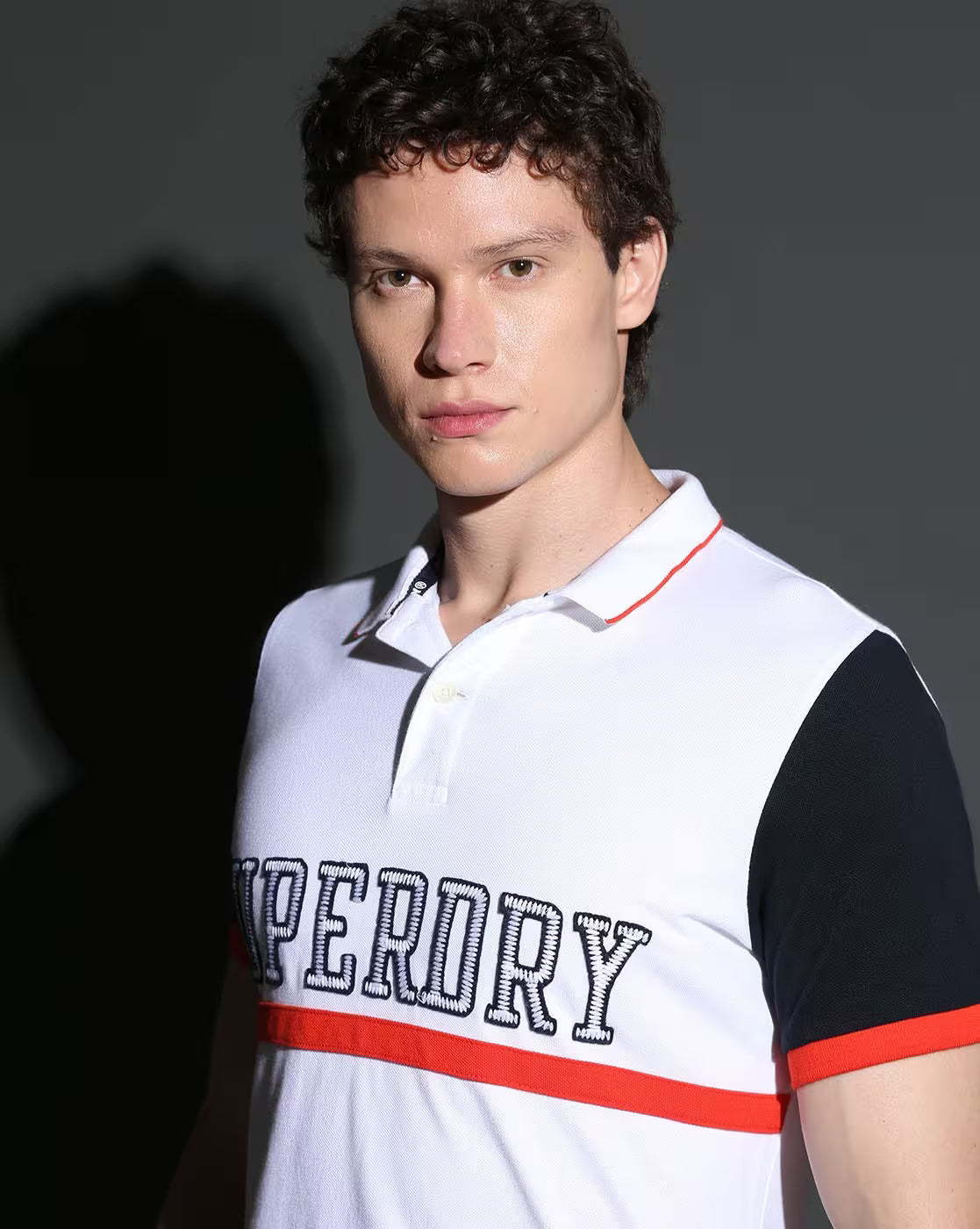 Superdry Premium Pique Polo in Crisp White with Bold Navy and Fiery Red Accents